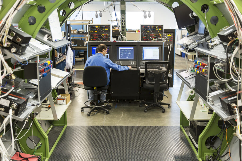 Electrical Engineer working in lab developing aircraft electronics